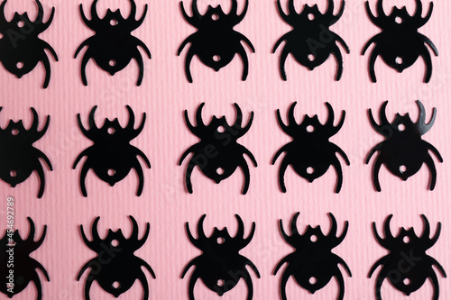 Flat lay composition with spiders on pink background © Atlas
