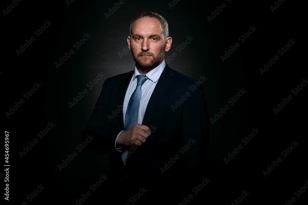 Man in a business suit on a black background Man in a business suit on a black background