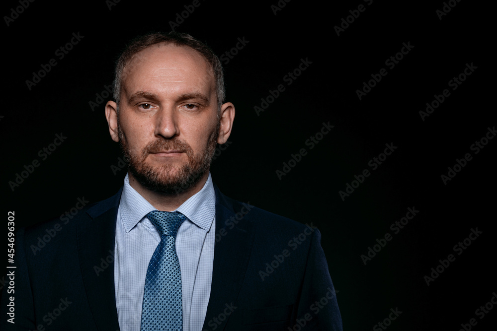 Man in a business suit on a black background Man in a business suit on a black background