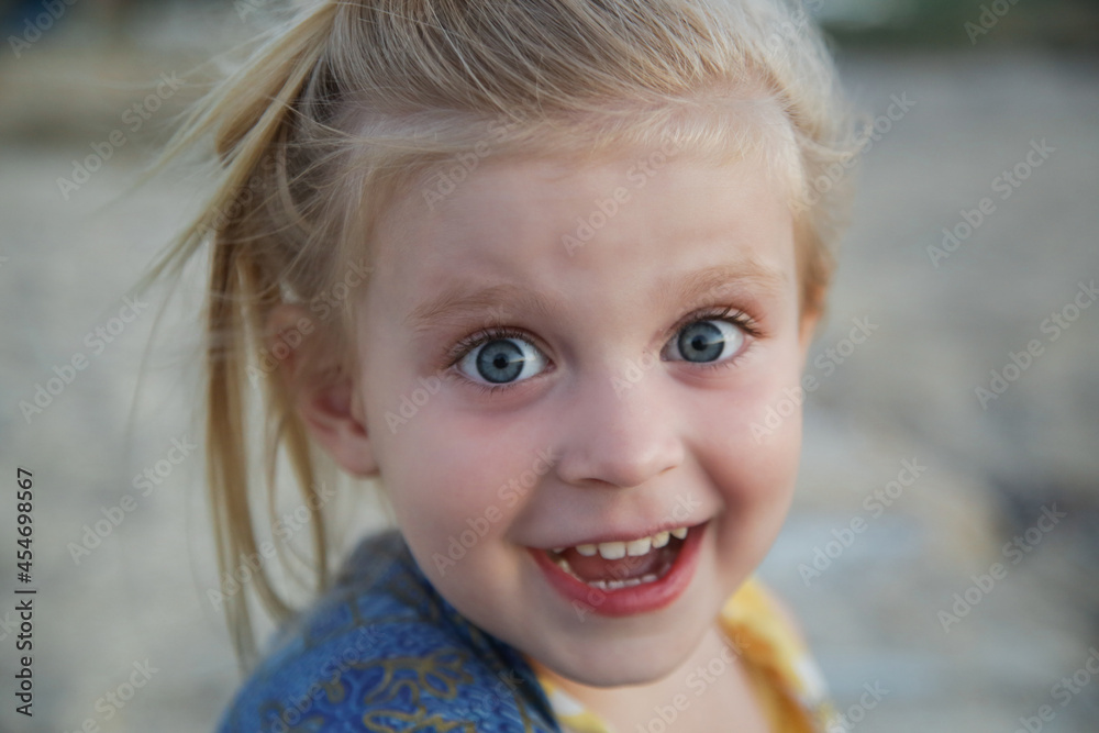 Candid portrait of toddler girl with funny face expression Candid portrait of toddler girl with funny face expression
