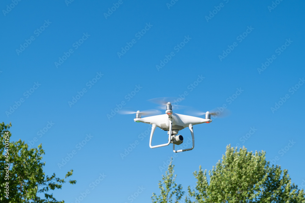Drone or quadrocopter while flying in the sky. Drone or quadrocopter while flying in the sky.
