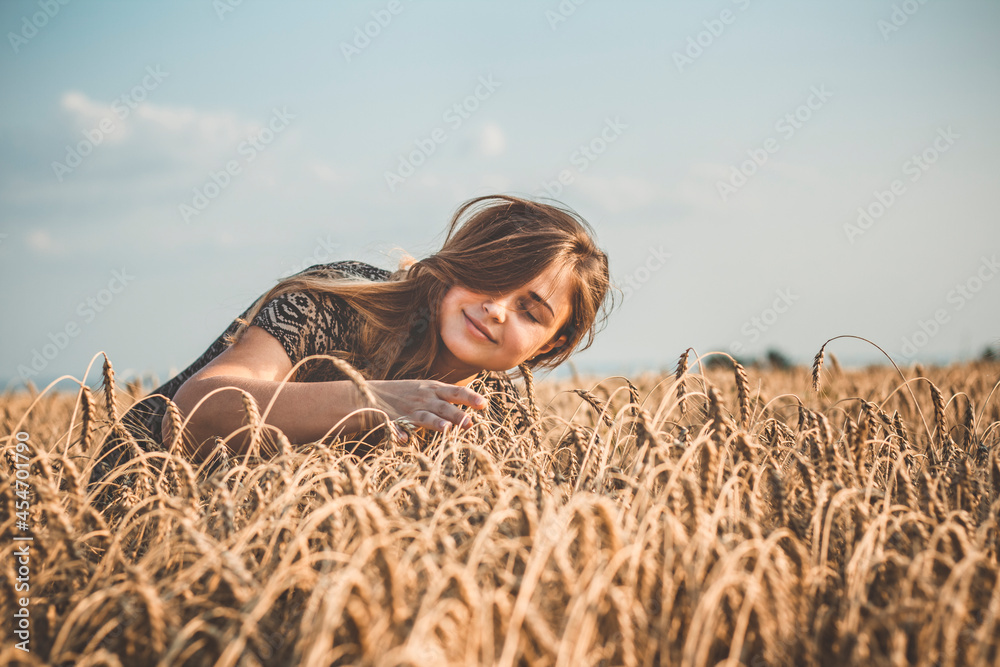 romantic beautiful young woman walking on wheat field with ripe spikelets, leisure concept romantic beautiful young woman walking on wheat field with ripe spikelets, leisure concept