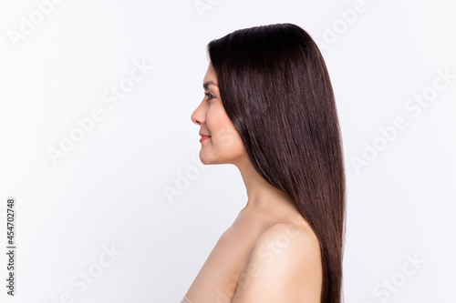 Side photo portrait brunette long hair woman smiling looking blank space isolated white color background