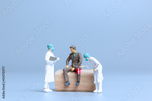 Miniature people Doctors treat rheumatism, osteoarthritis , World arthritis day concept photo