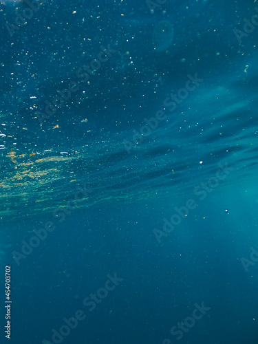 Sun light beams shining from above coming through the ocean deep blue water © REC Stock Footage