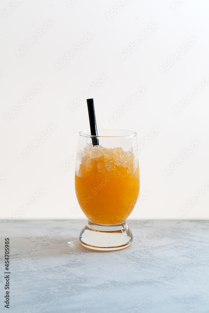 Spanish granizado orange, semi frozen dessert or drink made with juice and ice. Crushed ice with orange juice or syrup beverage Spanish granizado orange, semi frozen dessert or drink made with juice and ice. Crushed ice with orange juice or syrup beverage