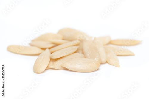 Micro close-up and details of Organic Indian white dry muskmelon (Cucumis melo) seed isolated over white background.