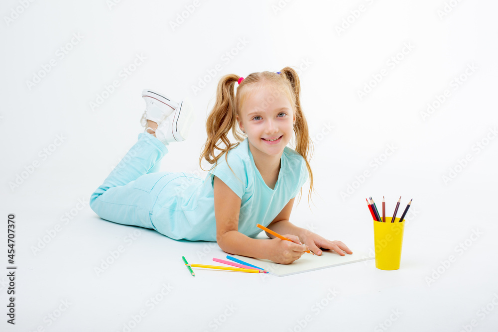 a little girl draws with pencils on a white background isolated a little girl draws with pencils on a white background isolated