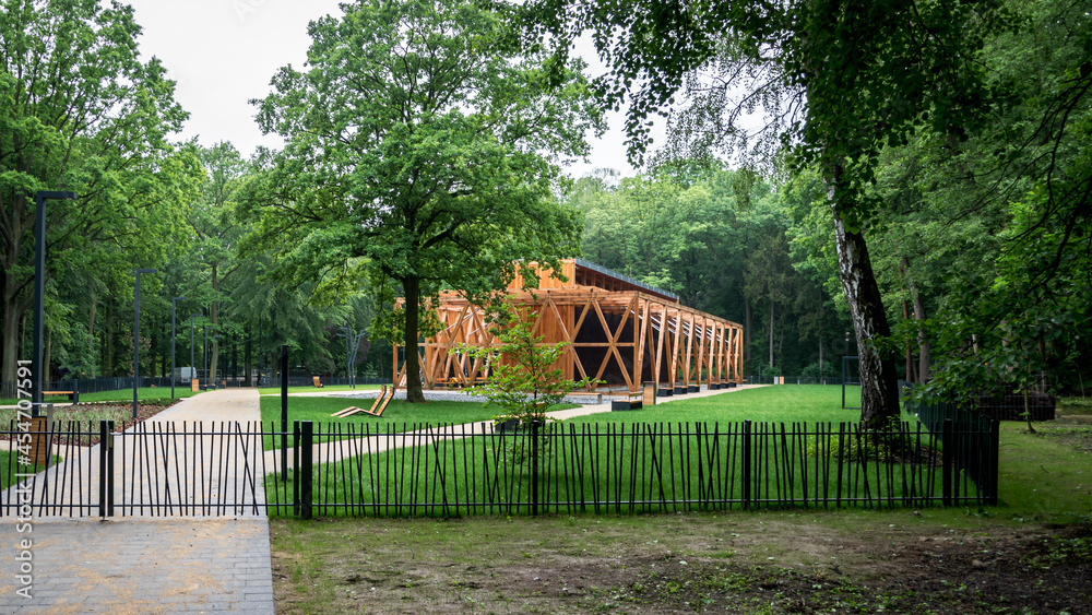 A graduation tower in a city park surrounded by greenery, a place for inhalation and recreation, a structure made of wood and blackthorn - obrazy, fototapety, plakaty 