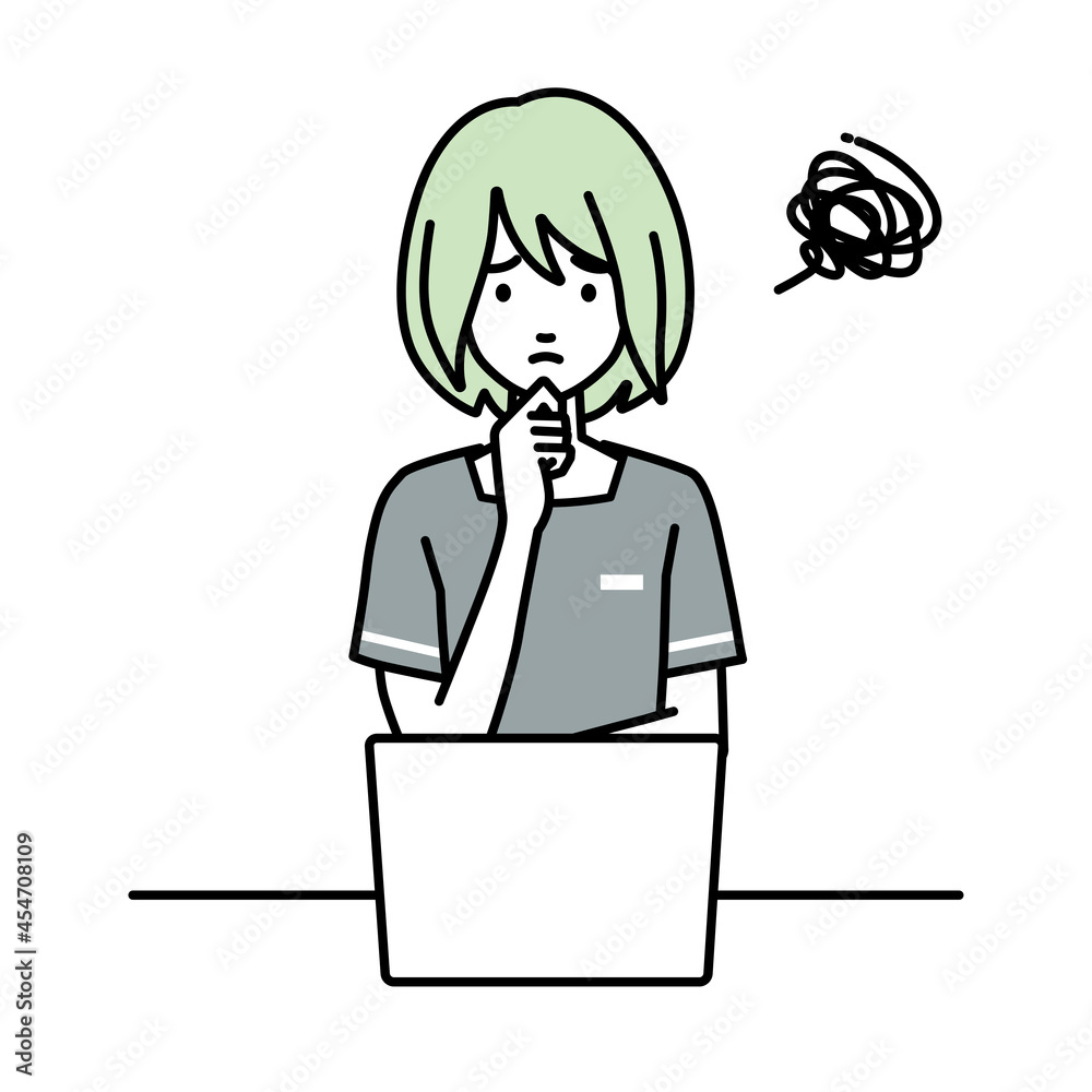 デスクで座ってPCを開いて困っているエステ店員の女性 デスクで座ってPCを開いて困っているエステ店員の女性