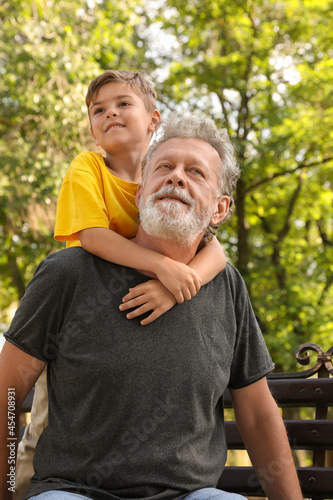 Senior man with his little grandson in park