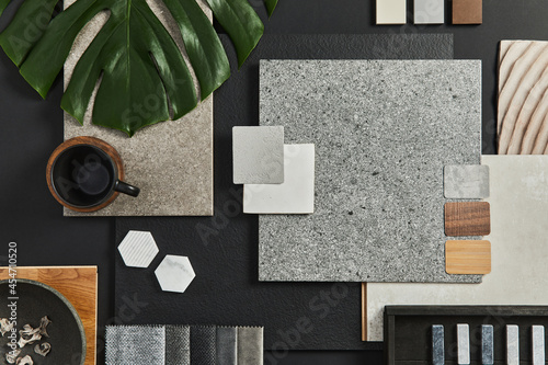 Flat lay of creative architect moodboard composition with samples of building, textile and natural materials and personal accessories. Top view, black backgroung, template. photo