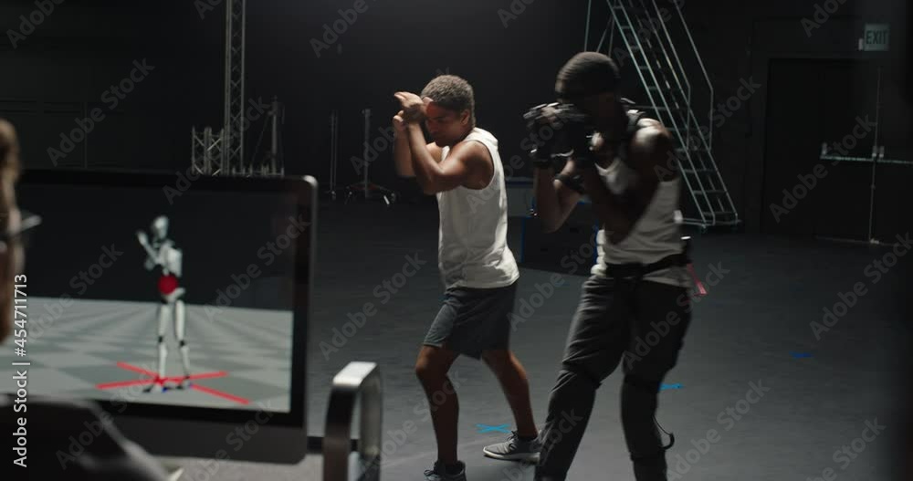actor wearing motion capture suit rehearsing martial arts with instructor teaching fighting moves mo-cap suit for 3d character animation for virtual reality technology