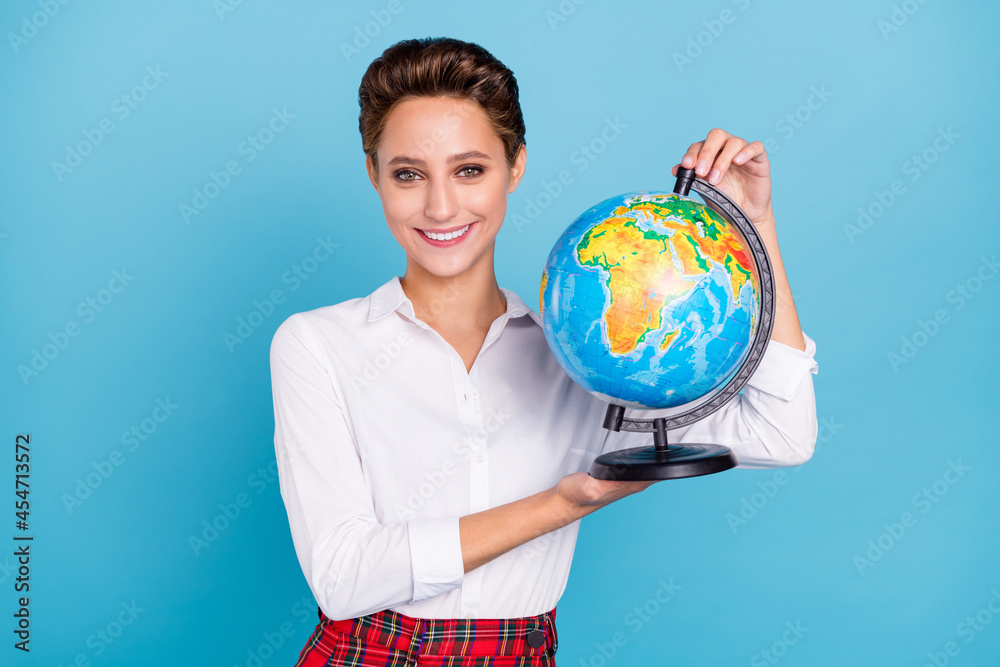 Fototapeta premium Photo of optimistic blond young lady hold globe wear shirt isolated on blue color background