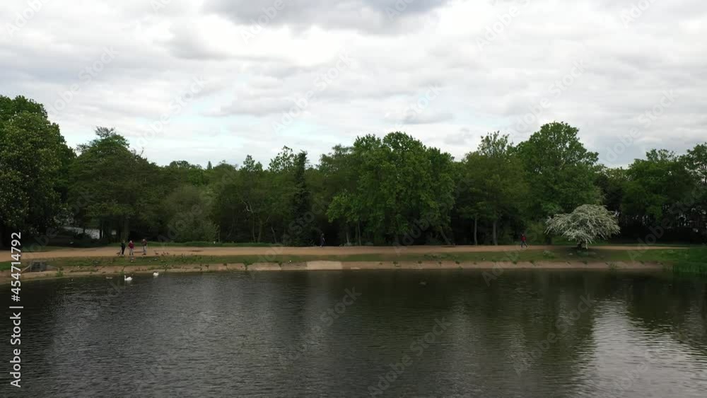People enjoying spring day in town greenery, lake in public park People enjoying spring day in town greenery, lake in public park