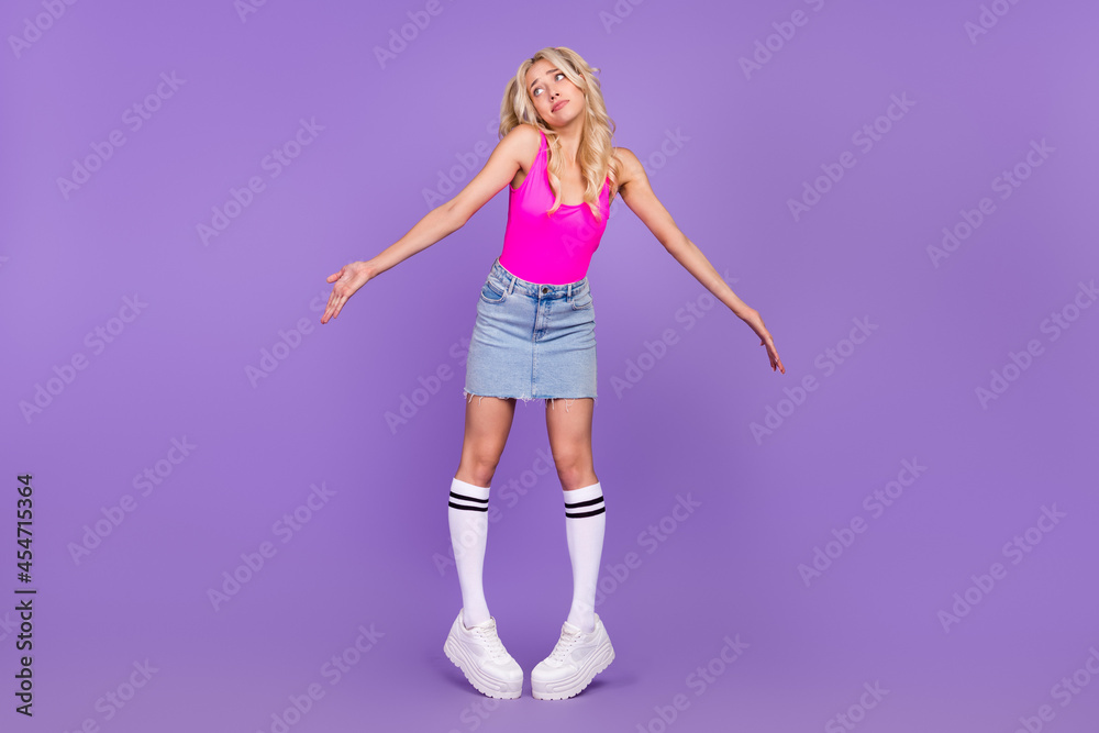 Full length body size view of desperate girl shrugging shoulders isolated over vivid purple violet color background