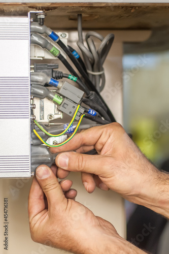 Close up of electrician engineer works with electric cable wires. Installation inspect. Electrical equipment
