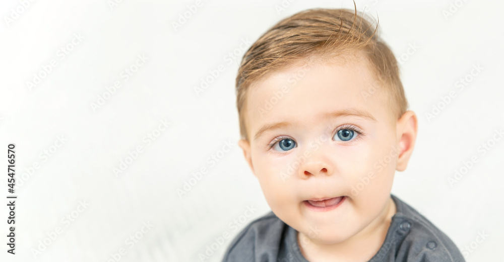 Headshot portrait of adorable smiling baby boy, shows tongue. Copy space, white background Headshot portrait of adorable smiling baby boy, shows tongue. Copy space, white background
