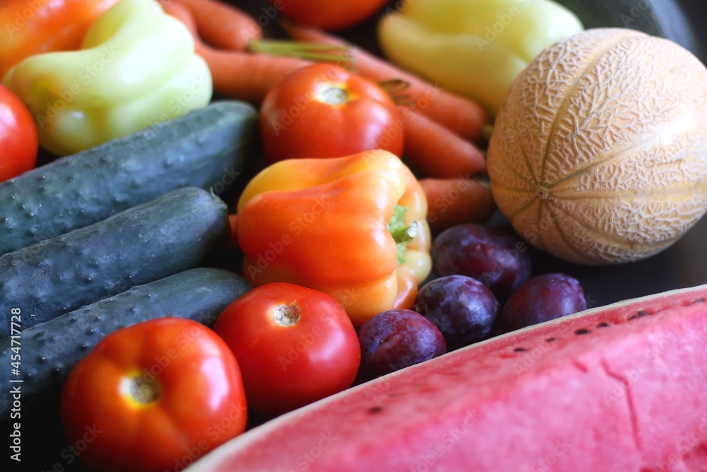 Various colorful summer fruit and vegetable on dark background. Selective focus.