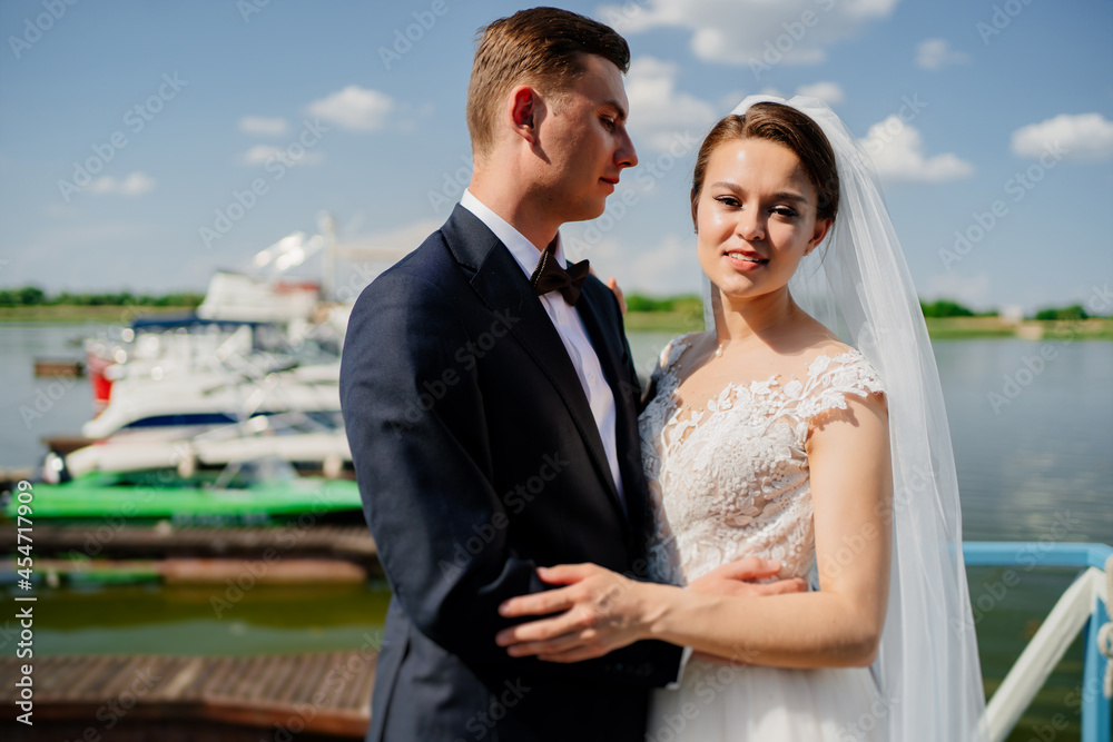 newlyweds on the pier. wedding by the water or on a yacht. newlyweds on the pier. wedding by the water or on a yacht.