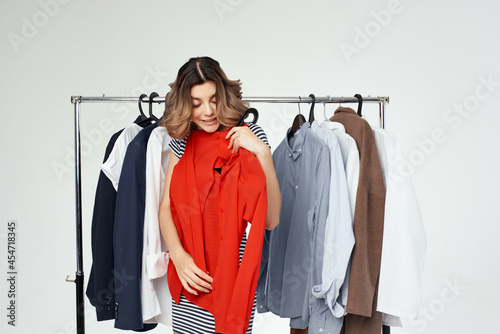 pretty woman near clothes shopaholic isolated background