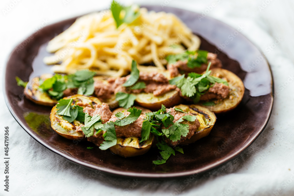 Plate with grilled eggplant slices served with a walnut sauce Plate with grilled eggplant slices served with a walnut sauce