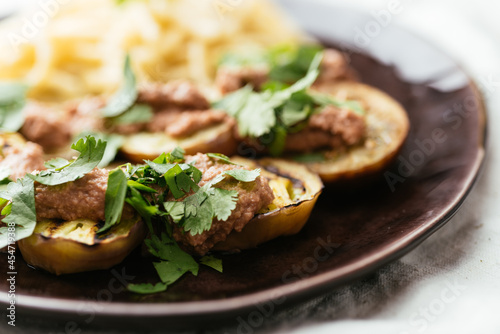 Plate with grilled eggplant slices served with a walnut sauce