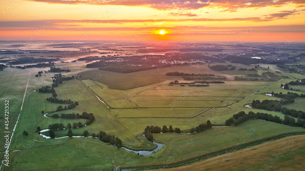 Dramatic summer sunrise. Panorama misty landscape. Foggy Morning on river aerial view