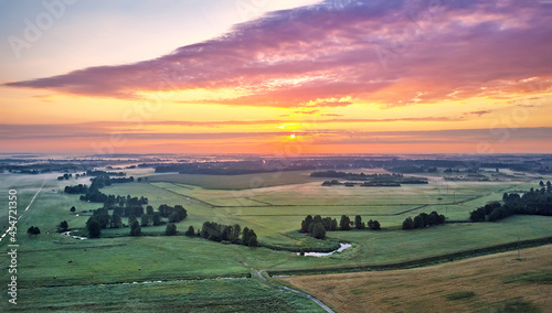 Obraz na płótnie Dramatic summer sunrise. Panorama misty landscape. Foggy Morning on river aerial view. Green fields and meadows w salonie
