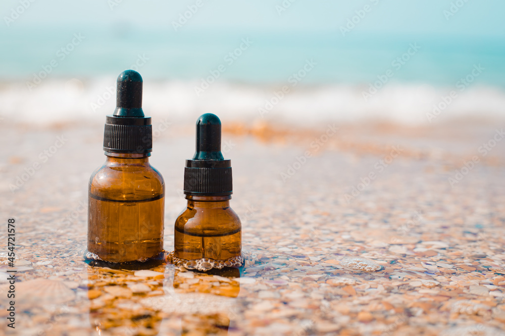 A bottle of cosmetic oil on the background of the sea . Cosmetic oil. Cosmetology. The sea wave. An oil based on algae. A bottle of cosmetic oil on the background of the sea . Cosmetic oil. Cosmetology. The sea wave. An oil based on algae.
