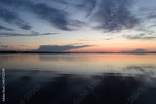 Obraz na płótnie Tranquility scenic lake in the twilight in pattern shadows clouds and afterglow sunlight w salonie