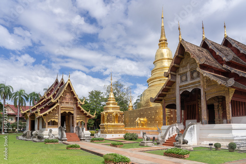 Beautiful panorama view of ubosot and golden stupa inside compound of famous landmark Wat Phra Singh buddhist temple, Chiang Mai, Thailand © Cyril Redor