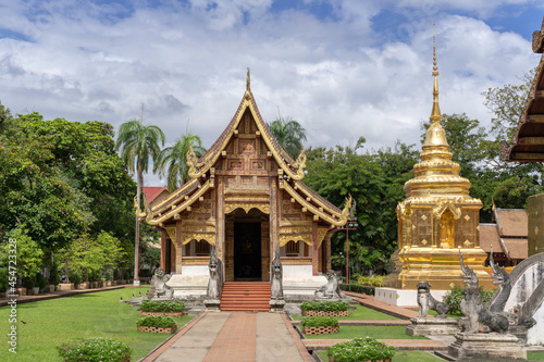 Beautiful landscape view of viharn Lai Kham and golden stupa inside compound of famous landmark Wat Phra Singh buddhist temple, Chiang Mai, Thailand