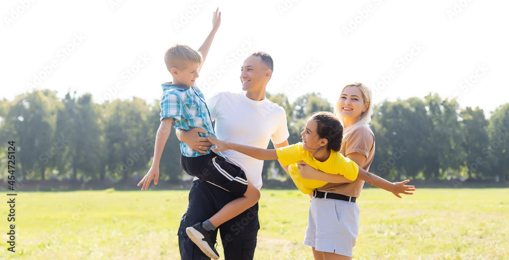 Obraz premium Happy family walking in field and holding hands
