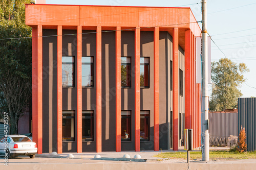 Black and red building in the city near a road. Office. District. Street. House. New. Development