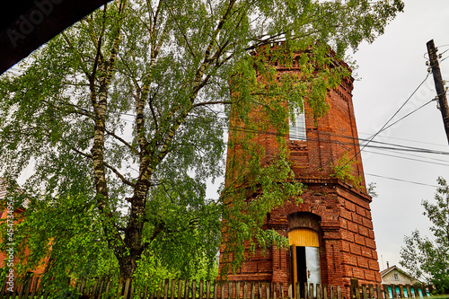 The bell tower of the Orthodox church, made of red bricks photo