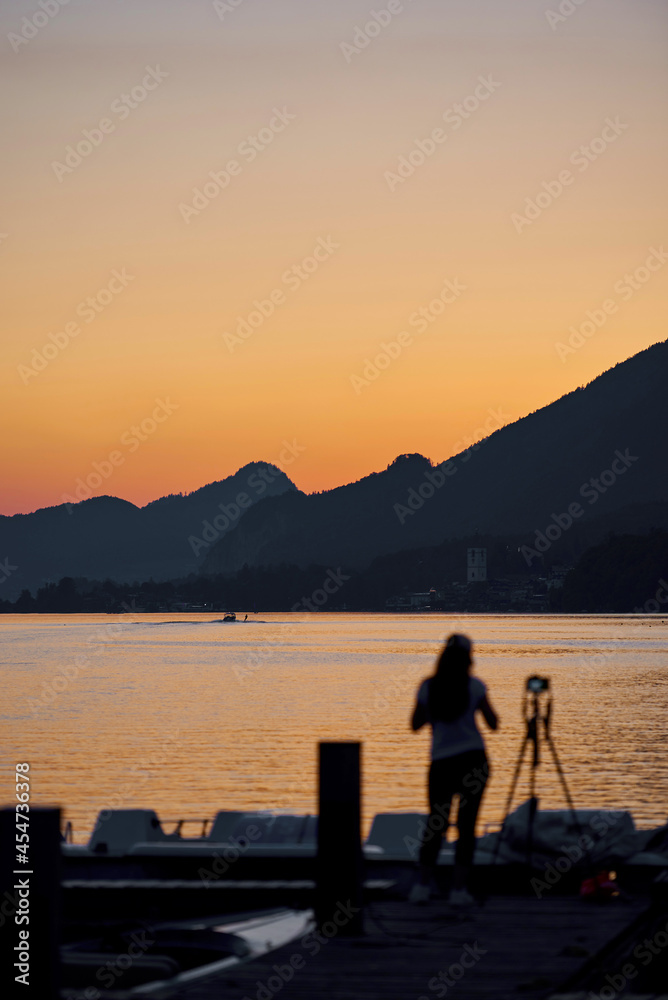 the girl photographs the sunset