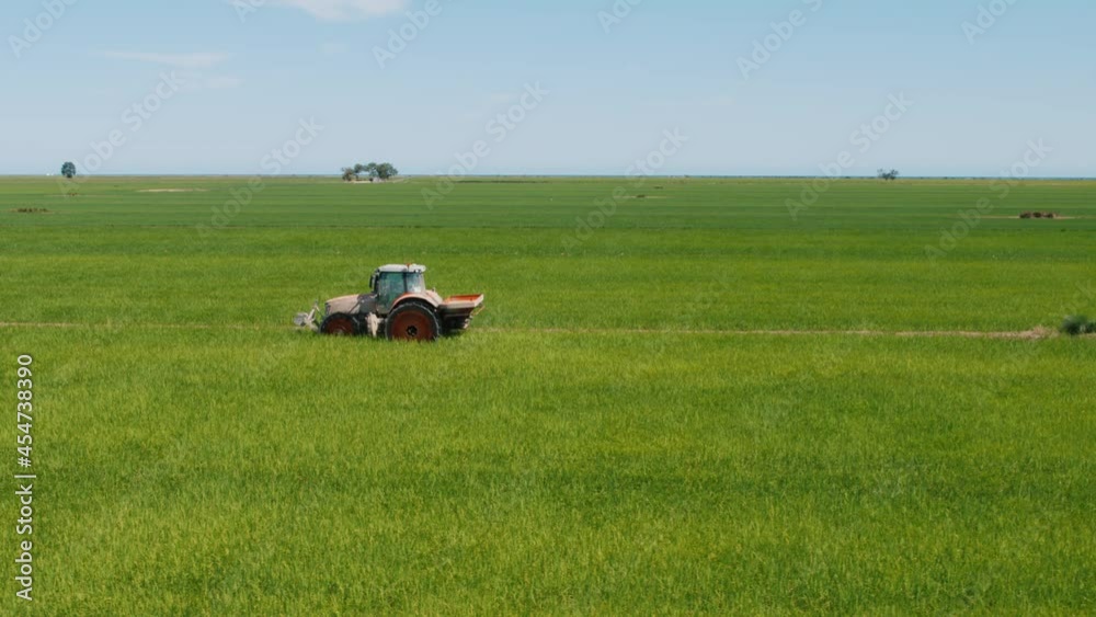 Aerial shot of a tractor harvesting on a green rice terrace in Europe