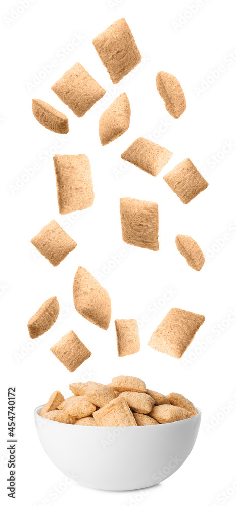 Sweet crispy corn pads falling into bowl on white background Sweet crispy corn pads falling into bowl on white background