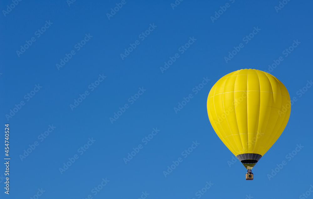 Yellow Hot air balloon on one side of the sky with space for text Yellow Hot air balloon on one side of the sky with space for text