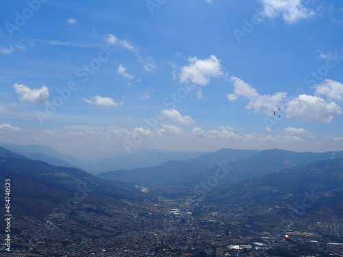 Medellin, Colombia - 20.05.2015: Paraglider flying above Medellin