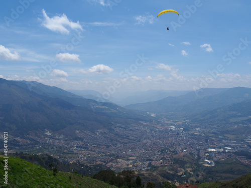 Medellin, Colombia - 20.05.2015: Paraglider flying above Medellin