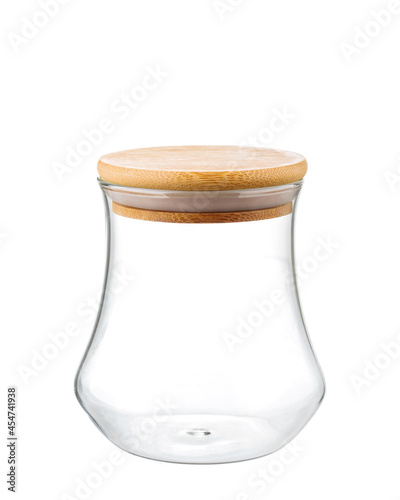 Empty glass kitchen jar with a round wooden cap, composition isolated over the white background