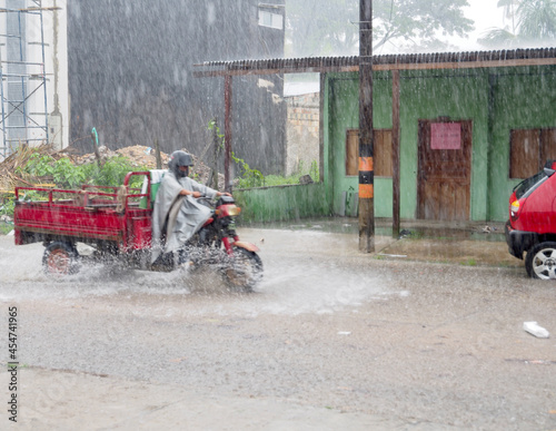 Tablou canvas Moped driving during a storm in Leticia, Colombia
