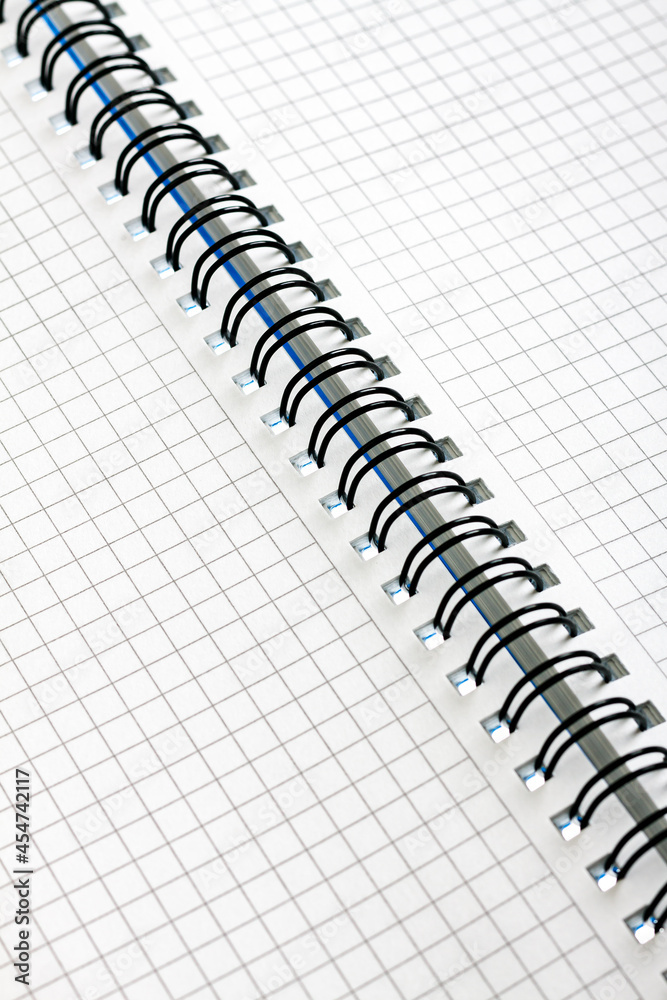 Open notebook with checkered sheets with a spring Open notebook with checkered sheets with a spring