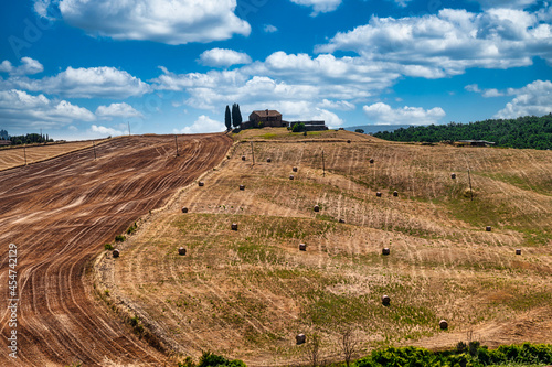 Typically Tuscany Landscape with acres and hayballs in summertime, Val d'Orcia, Siena Region, rolling landscape photo