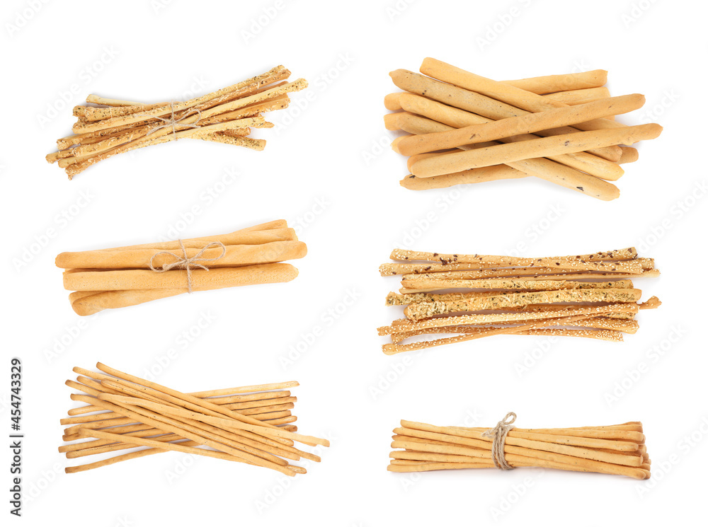 Set with delicious crispy grissini sticks on white background Set with delicious crispy grissini sticks on white background