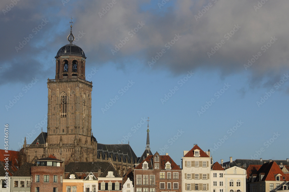 The facades of beautiful old buildings and the tower of the Great Church in the city of Deventer, The Netherlands