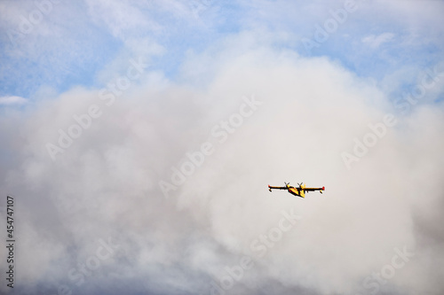 Hydroplane amidst ash clouds working to extinguish a forest fire
