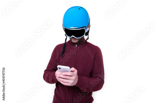 Portrait of a brutal man in a ski helmet and glasses with a mobile phone © makedonski2015